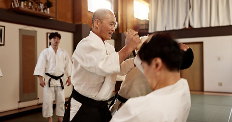 Image showing Aikido class, man and sensei for martial arts, learning and advice for combat at training, gym and dojo. Japanese people, master and sports with fight, workout and fitness for zen, conflict or club