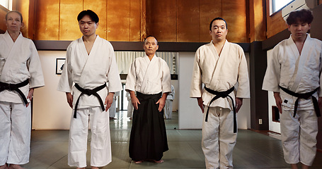 Image showing Japanese students, bow or learning aikido in dojo, training and modern martial arts for self defence or respect. Group, black belt class and sensei in instruction, honor and discipline in commitment