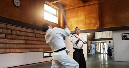 Image showing Aikido men, fight and bokken for martial arts, weapon or contest for black belt students at training, gym or dojo. Japanese people, wood sword and sensei for exercise, workout and fitness in battle