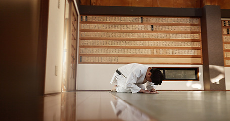 Image showing Japanese student, bow or man in dojo to start aikido practice, discipline or self defense education. Black belt master greeting, athlete learning respect or ready in fighting class or training alone