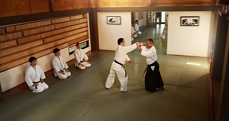 Image showing Japanese men, martial arts class or training in fight, modern or aikido to learn self defence. Sensei, black belt students and instruction in dojo place, sport and combat demonstration for discipline