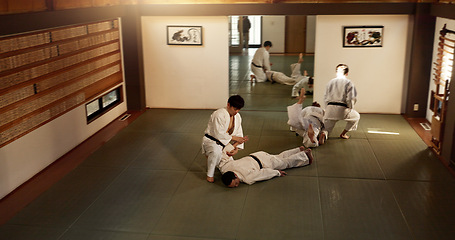 Image showing Japanese men, training and aikido fighting, modern martial arts and learning self defence. Respect, black belt students and instruction in dojo place and combat demonstration for discipline in class