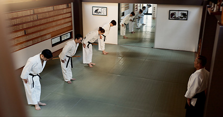 Image showing Japanese people, bow and learning aikido in dojo place in training and modern martial arts class of self defence. Group, black belt students and sensei with instruction and respect for discipline