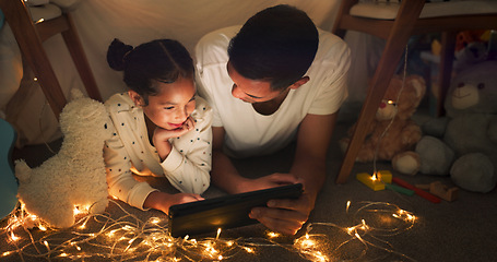 Image showing Tent, father and girl on tablet at night watching movies, online games and cartoon with fairy lights. Happy family, blanket and dad with child in bedroom on digital tech for bonding, relax and love