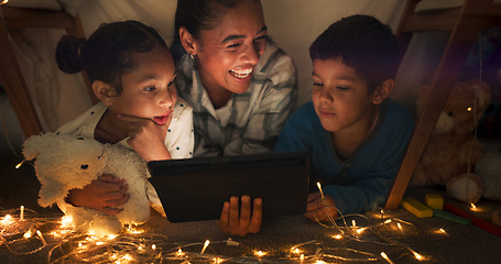 Image showing Funny, tablet and mother with children in a tent house streaming internet video, show or movie online in the night. Dark, digital and parent or dad relax with kids watching comedy in the evening