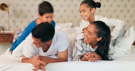 Image showing Happy family, mom and dad with children on bed, playing and bonding fun in home on weekend morning. Happiness, parents and kids joke in bedroom, playful quality time together and laughing with love.