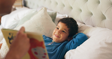 Image showing Dad, son and bed with book, story and reading together with learning, knowledge and happy in family home. Father, male kid and teaching at bedtime, care and love with bonding, bedroom and listening