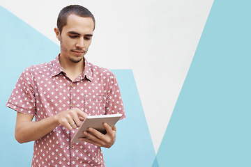 Image showing Tablet, search and man in studio for college newsletter, sign up or elearning registration on blue background. Digital, app or gen z student online for ebook streaming, research or upskill education