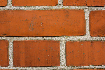 Image showing Building, design and closeup of red, brick wall for texture, background and pattern of exterior structure. Architecture, construction and surface of material, concrete and cement for decoration