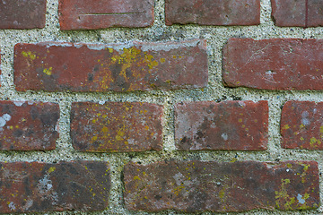 Image showing Building, old and closeup of red, brick wall for texture, background and pattern of exterior structure. Architecture design, construction and surface of material, concrete and cement for decoration