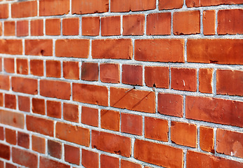 Image showing Building, city and closeup of red, brick wall for texture, background and pattern of exterior structure. Architecture design, construction and surface of material, concrete and cement for decoration