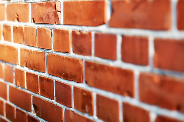 Image showing Building, pattern and closeup of brick wall in city for texture, background and design of exterior structure. Architecture, construction and surface of material, concrete and cement for decoration