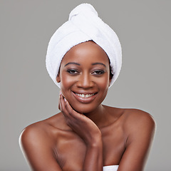 Image showing Woman, portrait and towel in studio for skincare cleaning or healthy transformation, shower or grey background. Black person, face and smile for morning routine with dermatology, hygiene or mockup