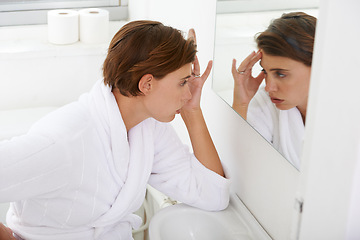 Image showing Woman, mirror and headache pain in bathroom for morning sickness or hangover, reflection or fatigue. Female person, hand and nauseous problem for pregnancy in home with bathrobe, migraine or sore