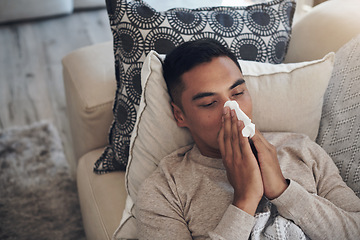 Image showing Sick, man and blowing nose with tissue for sinus, flu or illness on living room sofa above at home. Top view of tired male person with paper for sneeze, fever or influenza and infection on couch