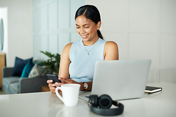 Image showing Laptop, coffee and woman with phone in kitchen networking on website, internet or mobile app. Technology, smile and female person typing email on cellphone by counter with computer in apartment.