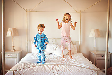 Image showing Children, happy and jumping on bed for fun together, play time or adventure in morning. Energetic, boy and girl excited during school holidays, break or vacation in parents bedroom for entertainment