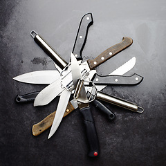 Image showing Kitchen, knives and tools with peeler on table in restaurant for cooking with professional set. Steel, service and metal slicer utensils on counter in cafe or culinary equipment for meal prep