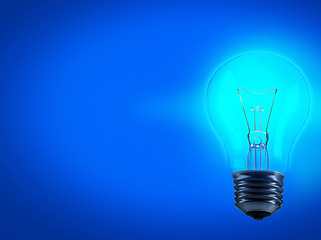 Image showing Lightbulb, energy and electricity in studio for idea with mockup space for inspiration, solution or genius thought. Power, glow light and science for knowledge or creative thinking on blue background