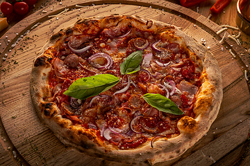 Image showing Homemade pizza on wooden board