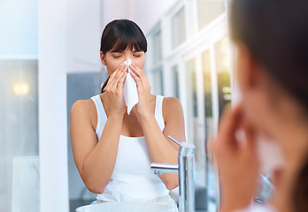 Image showing Woman, sick and allergies in bathroom for healthcare, virus and illness in morning for weather change. Asian female person, cough and tissue for sneezing, flu and reflection of medical problem.