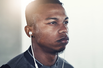 Image showing Fitness, earphones and man with thinking for exercise, workout planning and wellness podcast. Male person, serious and idea with headphones for music, audio streaming and cardio training in morning