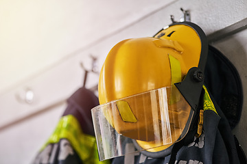 Image showing Helmet, clothes and fire fighter for safety gear in emergency service, security and hero, courage or risk. Rescue uniform in department with protection and ppe on hanger, ready for danger or accident