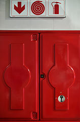 Image showing Fire, sign and box with extinguisher for emergency, danger and rescue from flames or heat. Firefighting, hydrant and red locker with gear, equipment and water hose for health and safety at station