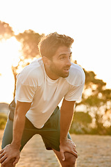 Image showing Man, breathing and rest after running outdoor, training for sport competition and sun in summer for exercise. Fitness, workout with athlete or runner in park, race or marathon with break or relax