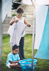 Image showing Backyard, grandmother and grandchild with laundry, help and chore with summer and bonding together. Family, senior woman and boy with clean clothes and activity with washing, outdoor and home