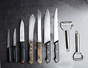 Image showing Knives, tools and kitchen equipment on table for professional chef, restaurant and culinary steel. Instrument, cutlery and blade for gourmet cafe, cutting and catering service in studio for meal prep