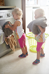 Image showing Kids, washing machine and siblings with laundry in house for learning, playing or fun bonding together. Cleaning, games and children help with towels at home for child development, housework or chore