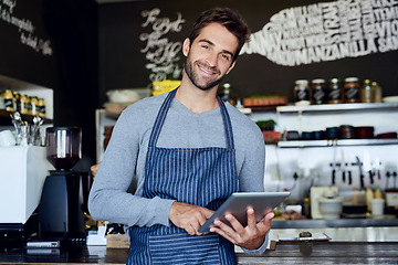 Image showing Small business, cafe and portrait of man with tablet checking online review, web or reservation in coffee shop. Networking, smile and restaurant manager, waiter or owner with digital app for service