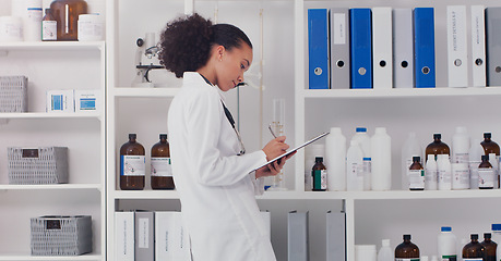 Image showing Woman, scientist and clipboard for inventory in lab stock room for equipment check and analyse products. Female pharmacist, checklist and bottles chemical supply in laboratory for research and work.