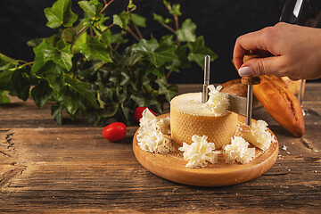 Image showing Woman slicing cheese