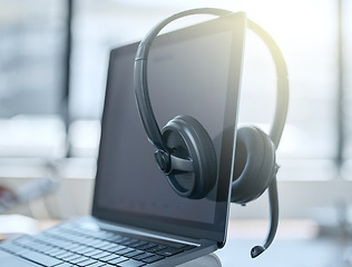 Image showing Laptop, headset and empty office in call center for help desk, customer service or telemarketing. Tech support, computer and headphones for communication, crm and tools for online consulting business