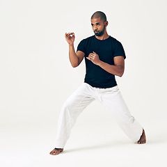 Image showing Man, studio and ready for attack on martial arts, action and karate exercise on white background. Black male person, mockup space and training for combat, fight and position of fitness in taekwondo