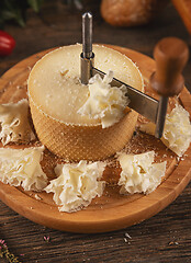 Image showing Cheese sliced with special knife