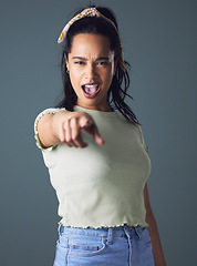 Image showing Woman, pointing and portrait in studio for you, choosing and decision on dark background for playful. Young people, crazy and gesture for choice or select with confident attitude and good mood