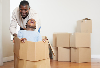 Image showing Black man, child and playing with box in new home for moving, relocation or property together. African dad and kid with smile or laughing in happiness for playful bonding or investment in living room