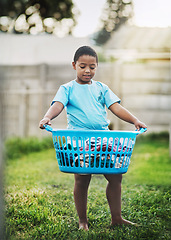 Image showing Boy, kid and backyard with basket or laundry for growth, child development and learning. Outdoor, son and smile at home with washing or clothes for childhood memories, fun and house activity