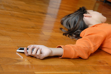 Image showing Teen girl lying on floor