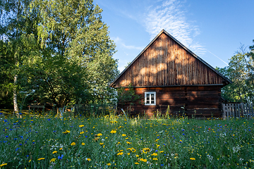 Image showing An old wooden cottage in the morning sun