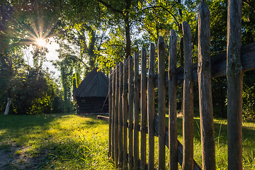 Image showing An old wooden cottage in the morning sun