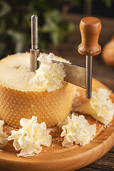 Image showing Cutting tete de moine cheese