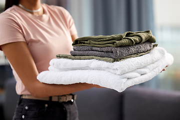 Image showing Home, clean laundry and woman with closeup, linen and hospitality with fabric towel, chore and housekeeping. Person, lady and girl in lounge, pile and cotton textile with stack, cleaner and maid