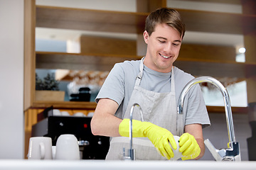 Image showing Cleaning, washing and dishes for man in home kitchen, chores and gloves for hand. Dirty, smile or hygiene with soap for bacteria prevention, germs and messy for disinfect crockery for male person