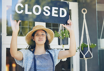 Image showing Closed, floral and woman with sign, recession and inflation with bankruptcy, unemployment or failure. Person, entrepreneur or worker with poster, stagflation or stress with store, emotion or business