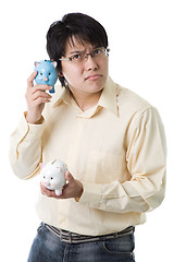 Image showing Asian businessman with piggy banks