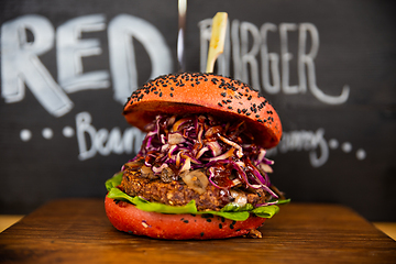 Image showing Fresh colorful vegan burgers with vegetables on counter at summer local food market - close up view. Outdoor cooking, gastronomy, vegetarian, street food concept.